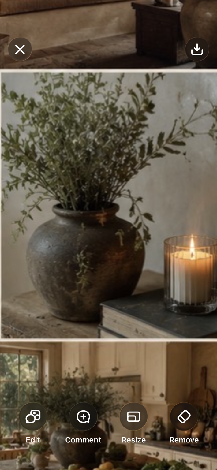 Dark earthenware vase, olive branches and candlelight styled as an organic interior detail